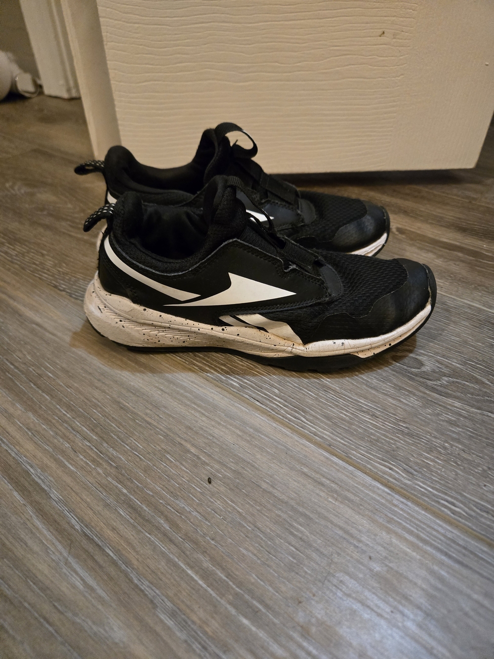 Kids Black and White Reebok Slip-On Sneakers